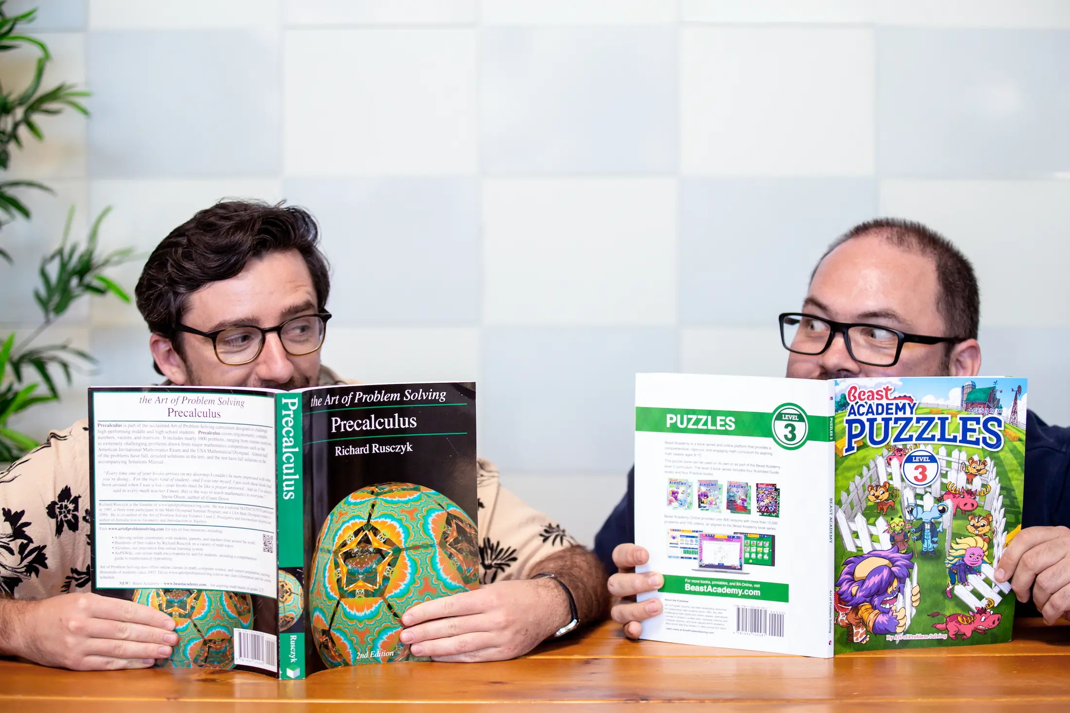 Photo of Andrew and Ben holding up AoPS textbooks